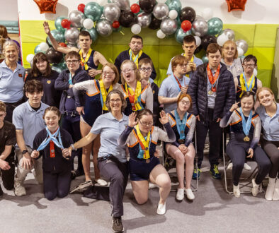 Coach with a large group of Tivoli Tigers gymnasts